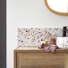 a wooden dresser topped with dishes and cups