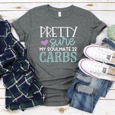 a t - shirt that says gather gobble shop next to some jeans and shoes