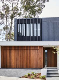 a modern house with wooden garage doors