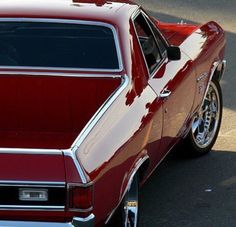 an old red car parked on the street