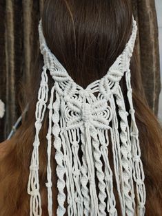 the back of a woman's head with white crochet