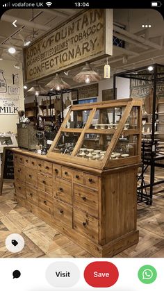 a store with wooden furniture and signs hanging from the ceiling in it's center