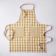 a yellow and white checkered apron with two straps