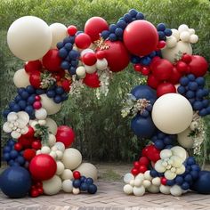 the balloon arch is decorated with red, white and blue balloons