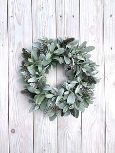 a wreath is hanging on the side of a wooden wall