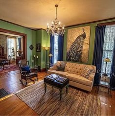 a living room filled with furniture and a chandelier hanging from the ceiling,