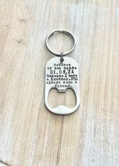 a bottle opener keychain with the words kitchen rules printed on it