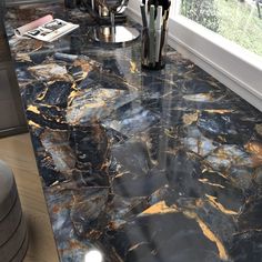 a marble counter top in a kitchen next to a window with vases on it