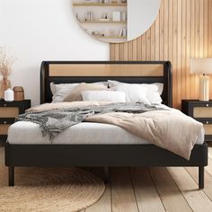 a large bed sitting on top of a wooden floor next to a dresser and mirror