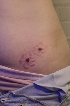 a pregnant woman's stomach with flowers on it