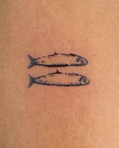 two fish on the back of a woman's arm