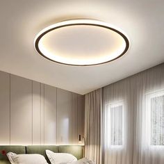 a bedroom with a round light above the bed