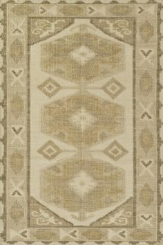 a beige and brown rug with an intricate design