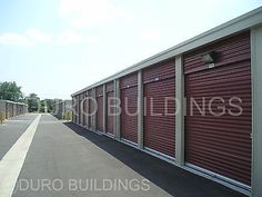 a row of red storage units in a parking lot