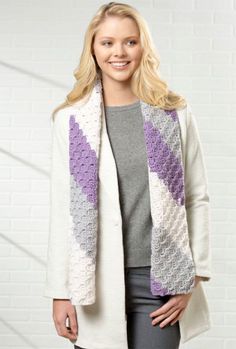 a woman wearing a white jacket and purple scarf