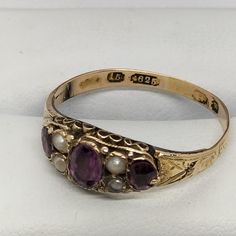 Victorian 15 Ct Solid Gold Ring With Three Amethyst & Four Seed Pearl the ring size is P. Hallmarked 15 Ct (625) Gold Birmingham Victorian ERA (1837 - 1901) In such beautiful condition for the age Antique Oval Multi-stone Ring, Victorian Multi-stone Yellow Gold Rings, Antique Pearl Ring With Gemstone, Antique Multi-stone Ruby Ring, Victorian Yellow Gold Birthstone Ring With Gemstone, Victorian Yellow Gold Birthstone Ring, Victorian Style Yellow Gold Birthstone Ring, Heirloom Purple Ring With Rose Cut Diamonds, Antique 14k Stamped Amethyst Ring