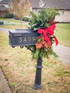 a mailbox decorated with red and green flowers