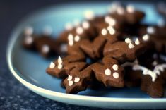 a blue plate topped with lots of brown and white stars covered in icing on top of a table