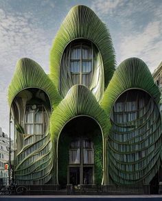 the building is made out of green leaves and has three windows on each side,