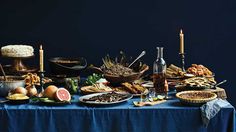 a blue table topped with lots of food