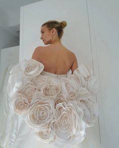 a woman in a wedding dress made out of flowers