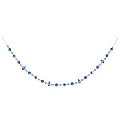 a necklace with blue beads and silver chains