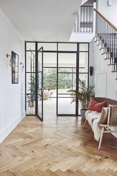 a living room filled with furniture and a staircase leading up to the second floor area