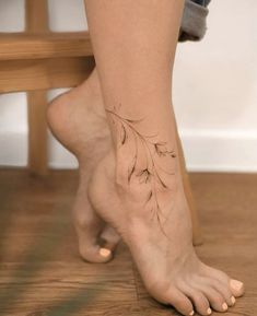 a woman's foot with a small tattoo on the side of her left leg