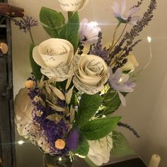 a vase filled with white and purple flowers