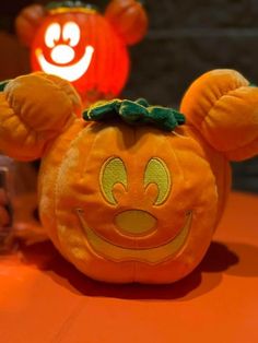 an orange pumpkin shaped like mickey mouse