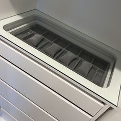 the drawer is open and has several compartments in it for storing items or other things