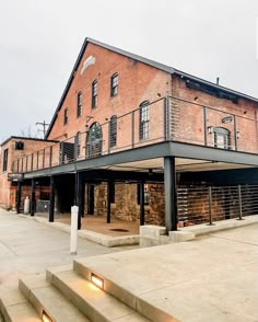 an old brick building with stairs leading up to it