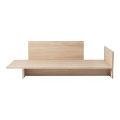 a wooden shelf sitting on top of a white wall in front of a white background