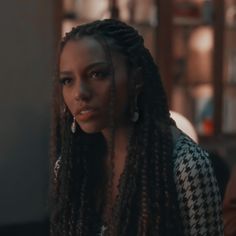 a woman with long dreadlocks looking at the camera