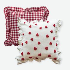 two red and white pillows with hearts on them