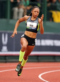 a woman running on a track in a black and white photo