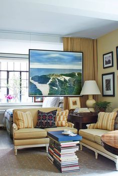 a living room filled with lots of furniture next to a large painting on the wall