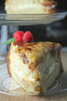 a piece of cake on a plate with raspberries