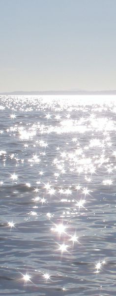 the sun shines brightly on the water as it reflects off in the ocean surface