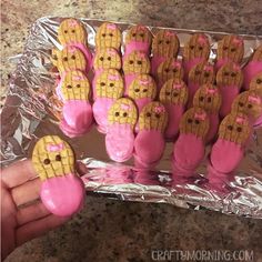 there are many pink and yellow cookies in the shape of corn on the cob