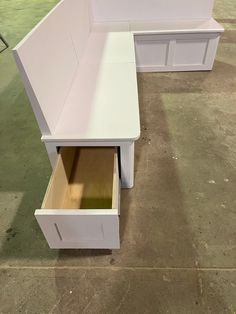 two white benches with open drawers on the bottom and one bench is missing its lid