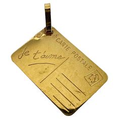 A French 18 karat (18K) yellow gold love letter charm pendant designed as a postcard with blank address field, stamp and the words 'Je t'aime' in cursive to one field. Stamped with the eagle's head for French manufacture and 18 karat gold and an unknown maker's mark. Dimensions: 1.7 x 1.2 x 0.05 cm (not including jump ring) Weight: 1.24 grams (Chain not included) Gold Heart Locket, In Cursive, Lucky Horseshoe, Letter Charm, Locket Charms, Love Charms, Letter Charms, Heart Locket, Vintage Jewels