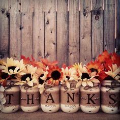 five mason jars with sunflowers and the words thanks written on them