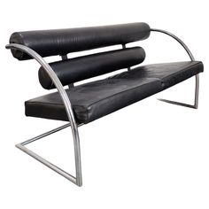 a black leather and chrome bench with armrests