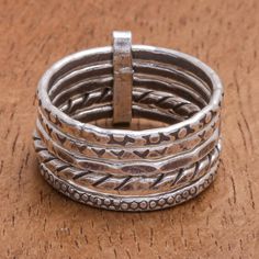 A distinct pattern marks each of the five bands on this pretty ring from Thailand's Pakaon Sojintarit. Hand crafted from 950 Karen silver the individual bands are linked together forming a single ring adorned with oxidized designs. Pretty Ring, Single Ring, On My Mind, Silver Band Ring, Pretty Rings, Silver Band, My Mind, Band Ring, Wrap Bracelet