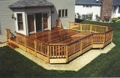 a wooden deck in front of a house