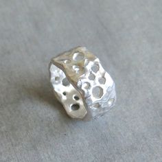 "This delicate organic shaped ring/ band is fully handmade of solid sterling silver with randomly arranged holes of different sizes. The irregular molten texture catches the light and sparkles. The model of each ring is carefully handmade of wax and cast in my home studio's foundry. The ring is elegant, not too chunky on the finger and very comfortable to wear. It is a sturdy, lasting piece of jewelry.  This gorgeous ring ring is ideal for everyday wear and it will also look amazing with a festi Wax Silver Jewelry, Silver Ring Chunky, Clay Silver Ring, Silver Thumb Ring, Art Clay Silver Ring, Organic Silver Jewellery, Silver Ring Handmade, Silver Clay Ring Ideas, Chunky Silver Ring