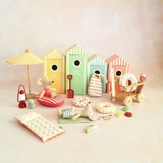 a group of toys sitting next to each other on a white surface with an umbrella