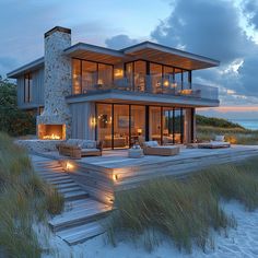 a large house on the beach with stairs leading up to it's second story