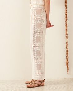 A person stands in profile wearing the Colette Picnic Eyelet Pant Pastel, Pastel Pants, Pants Details, Pants Cotton, Summer Favorites, French Seam, Summer 24, Diamond Shaped, New Arrival Dress